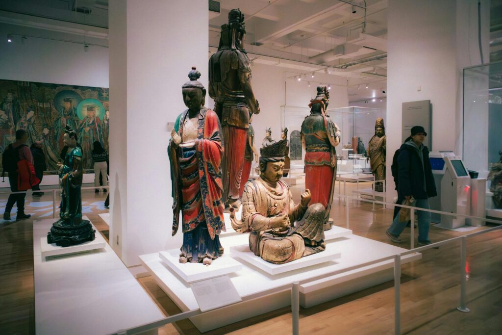 Explore a diverse art exhibit featuring traditional Asian sculptures in a Toronto museum.